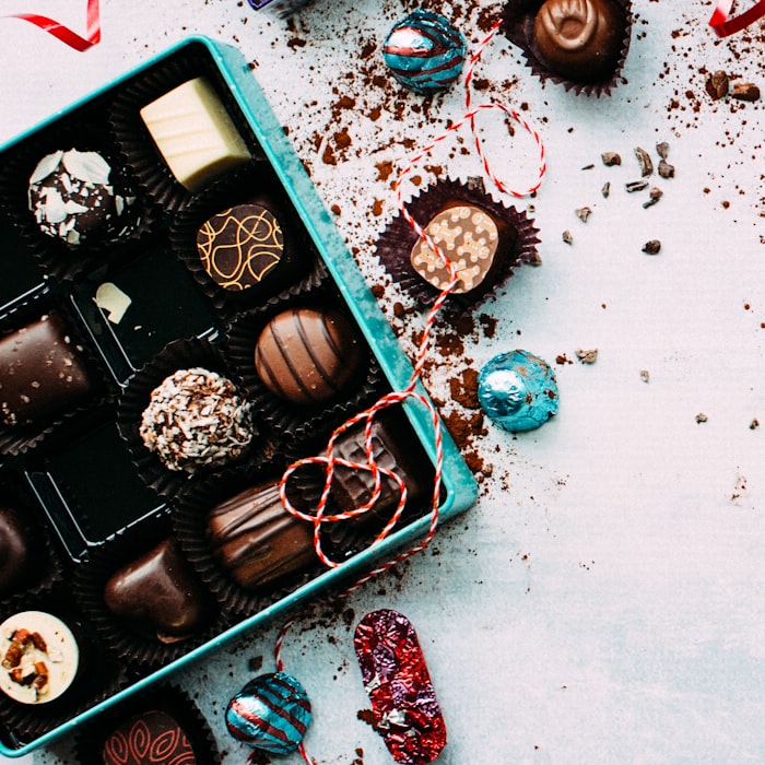 An open gift box of assorted handmade chocolate treats