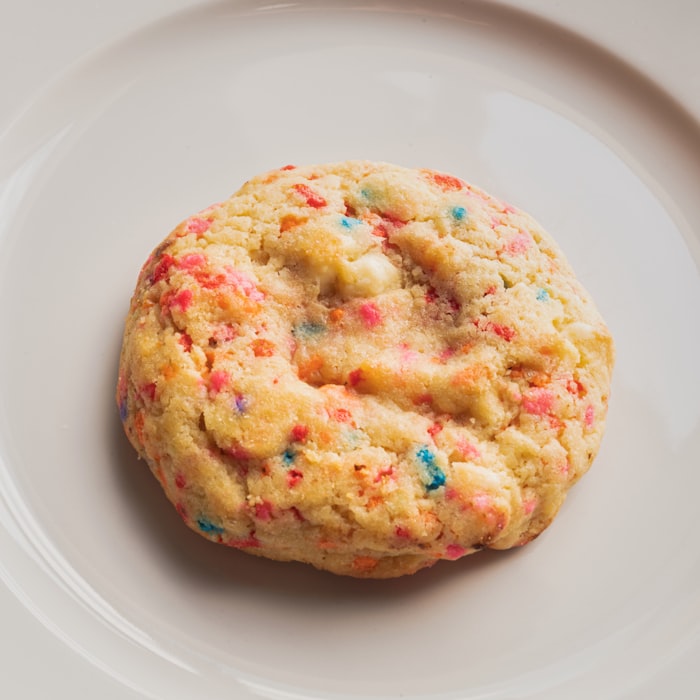 A thick funfetti cookie scattered with coloured sprinkles